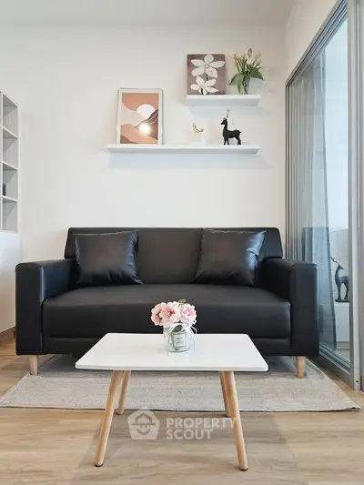 Modern living room with sleek black sofa and stylish decor
