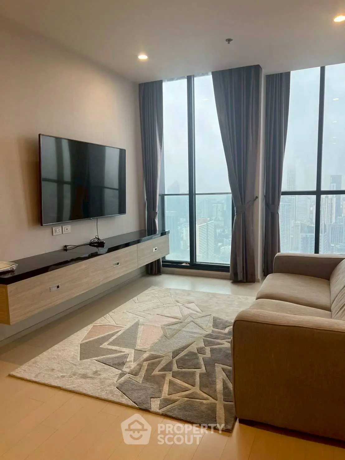 Modern living room with floor-to-ceiling windows and city view