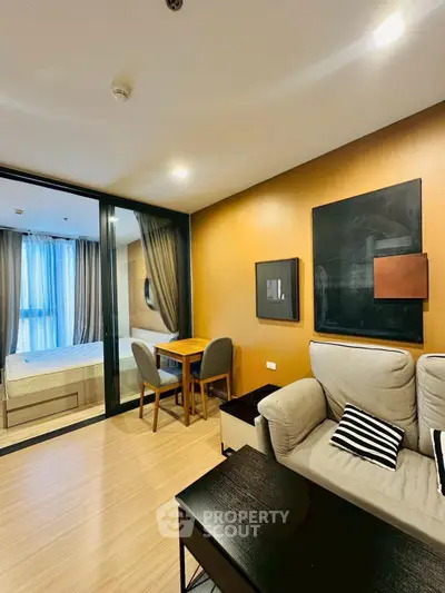 Modern living room with cozy seating and stylish decor in a contemporary apartment.