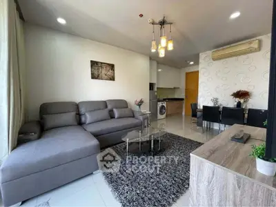 Modern living room with stylish furniture and open kitchen layout in a cozy apartment.