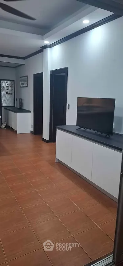 Modern living room with sleek furniture and tiled flooring