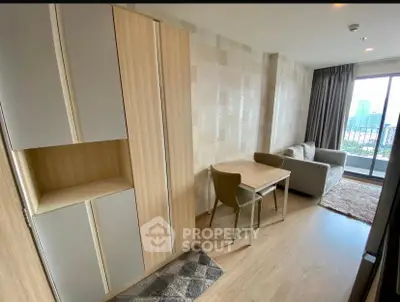 Modern living room with stylish furniture and city view balcony, perfect for urban living.