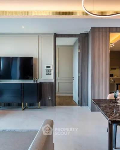 Modern living room with sleek TV setup and elegant dining area