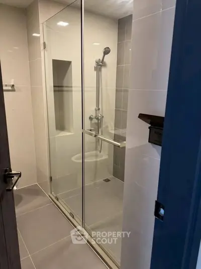 Modern bathroom with glass shower enclosure and sleek tile design
