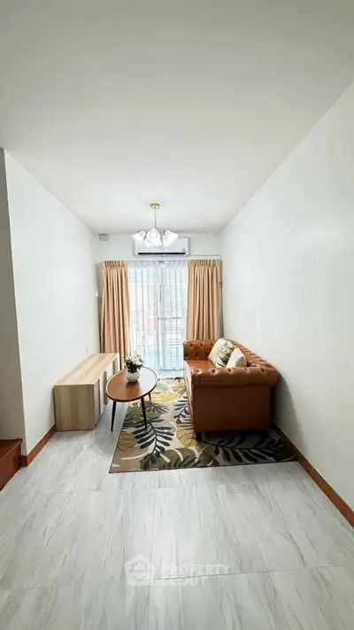 Charming living room with cozy sofa and elegant decor, perfect for relaxation and entertaining.