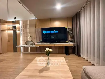 Modern living room with sleek wooden flooring and stylish TV setup