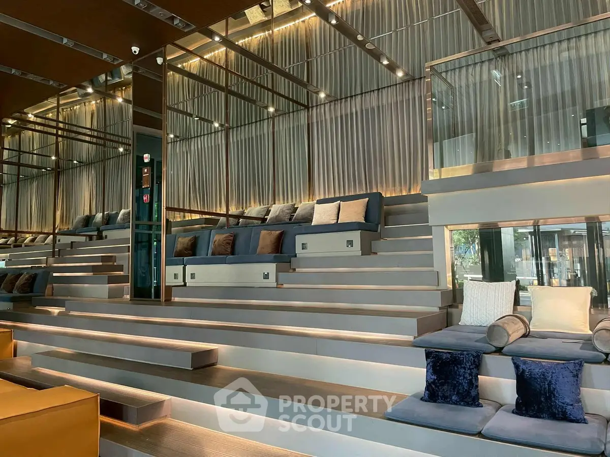 Luxurious modern lobby with tiered seating and elegant lighting, perfect for relaxation and social gatherings.