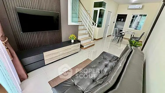 Modern living room with sleek furniture and open dining area, perfect for contemporary living.