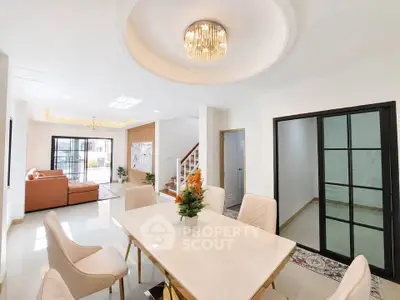 Elegant dining room with modern chandelier and spacious living area in luxury home