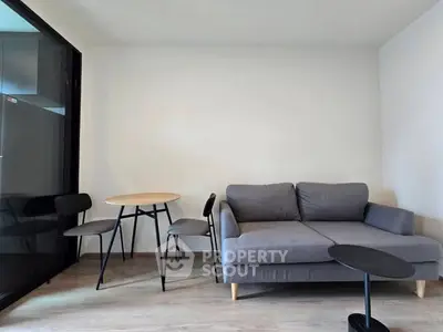 Modern living room with stylish gray sofa and minimalist furniture