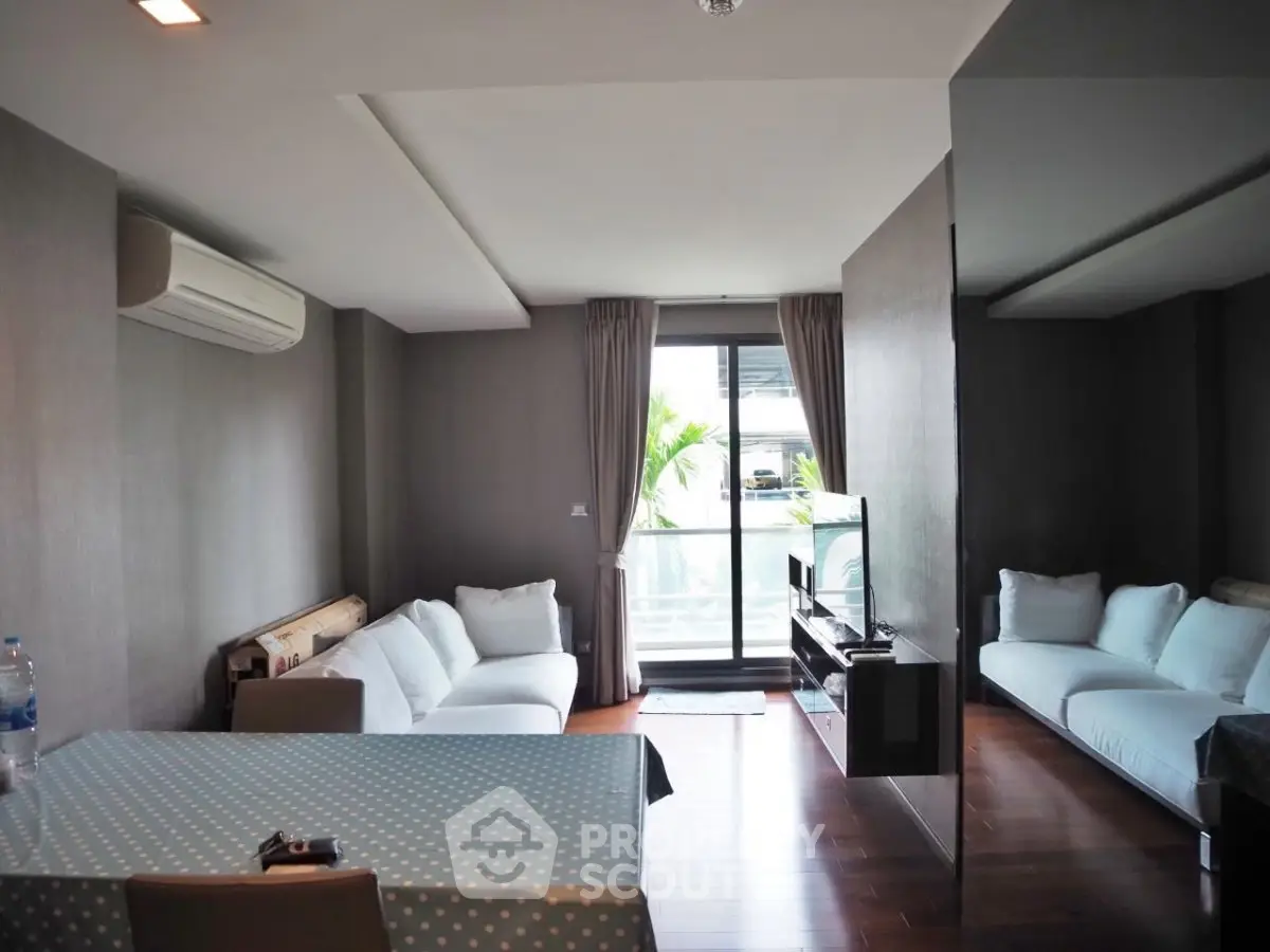 Modern living room with sleek design and balcony access in urban apartment