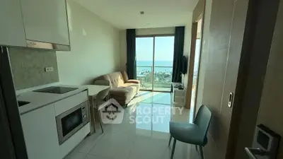 Modern apartment with stunning sea view, featuring open kitchen and cozy living area.