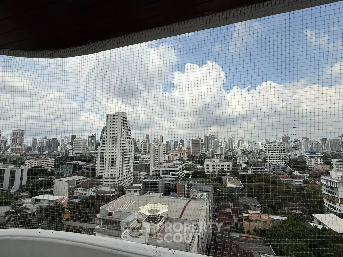 Stunning cityscape view from a high-rise balcony showcasing urban skyline and architectural diversity.
