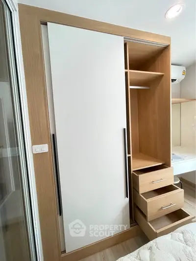 Modern bedroom with built-in wooden wardrobe and sliding doors, showcasing efficient storage solutions.