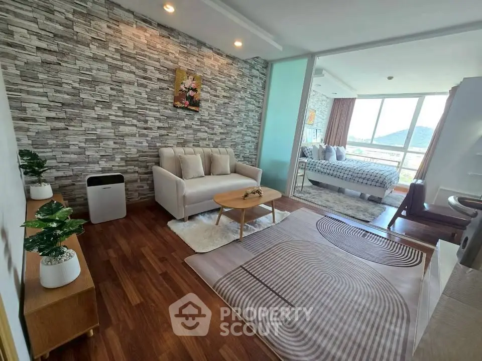Modern open-plan living room with stylish decor and stunning mountain view from the bedroom.