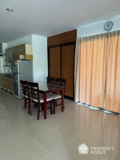 Spacious dining area with modern kitchen and natural light