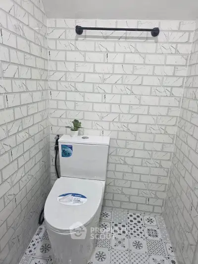 Modern bathroom with stylish tile design and sleek toilet fixture.