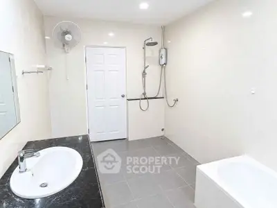Spacious modern bathroom with sleek fixtures and bathtub