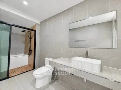 Modern bathroom with sleek fixtures and spacious shower area