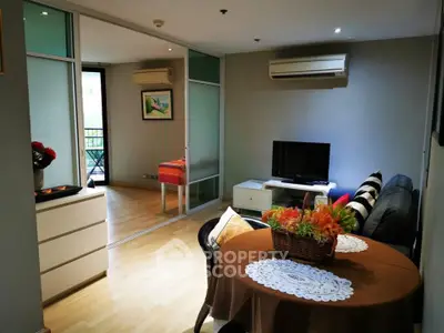 Charming living room with modern decor and balcony view in a cozy apartment.
