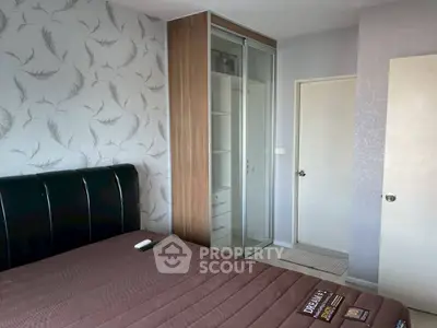 Cozy bedroom with modern decor and built-in wardrobe, perfect for comfortable living.