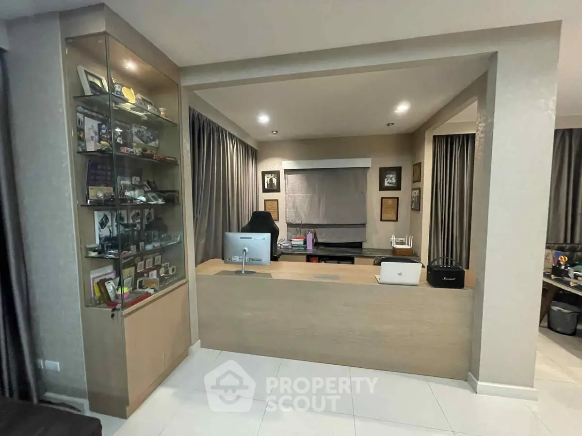 Modern home office with sleek desk and display cabinet