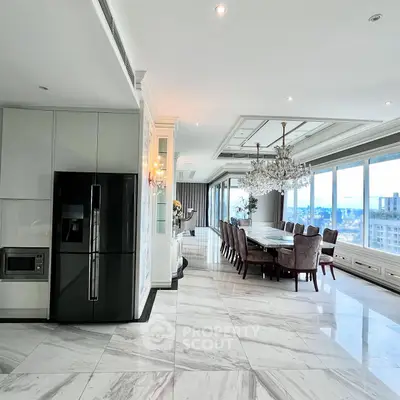 Luxurious open-plan kitchen and dining area with marble floors and city view.