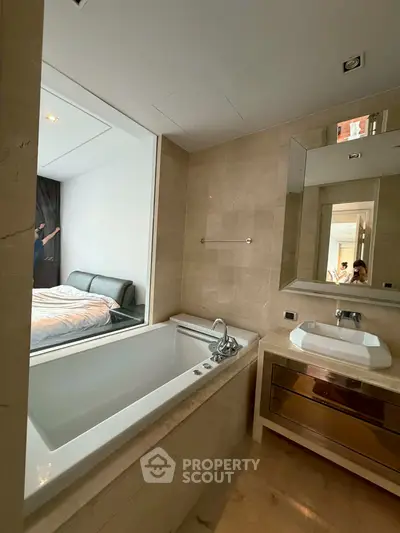Luxurious bathroom with modern bathtub and sleek vanity in upscale apartment
