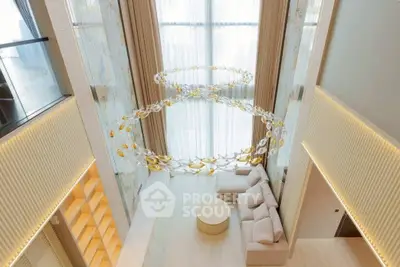 Luxurious modern living room with high ceilings and elegant chandelier