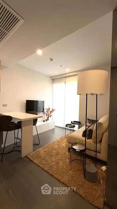 Modern living room with cozy seating and stylish decor in a contemporary apartment.