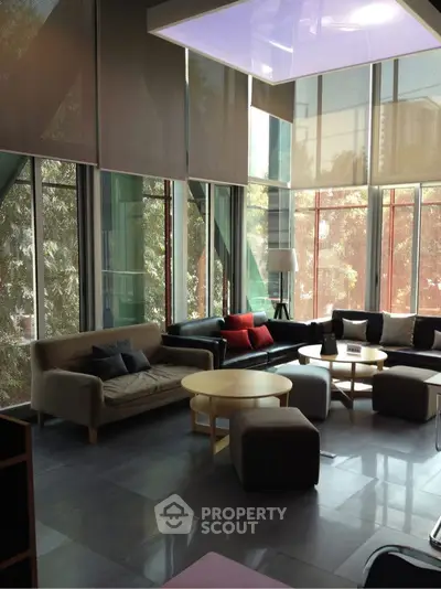 Spacious modern living room with large windows and stylish furniture