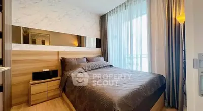 Modern bedroom with elegant decor and large window for natural light