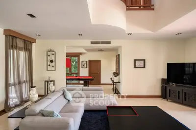 Luxurious modern living room with elegant decor and spacious layout, featuring a stylish sectional sofa and entertainment area.