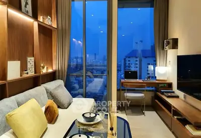 Modern living room with city view, stylish decor, and cozy ambiance.