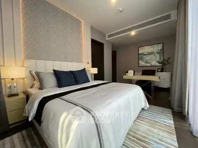 Luxurious bedroom with modern decor and natural light, featuring a cozy bed and stylish furnishings.