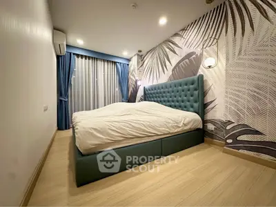 Modern bedroom with stylish wallpaper and elegant blue bed, featuring floor-to-ceiling curtains and wooden flooring.