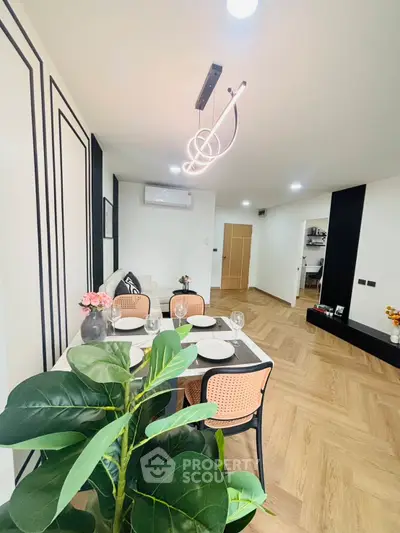 Modern dining area with stylish lighting and elegant decor in a spacious living room.