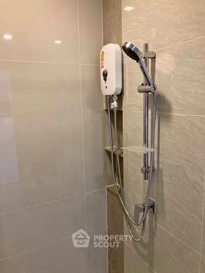 Modern bathroom with sleek shower unit and tiled walls, perfect for a contemporary home.