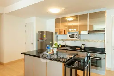 Modern kitchen with sleek black countertops and stainless steel appliances