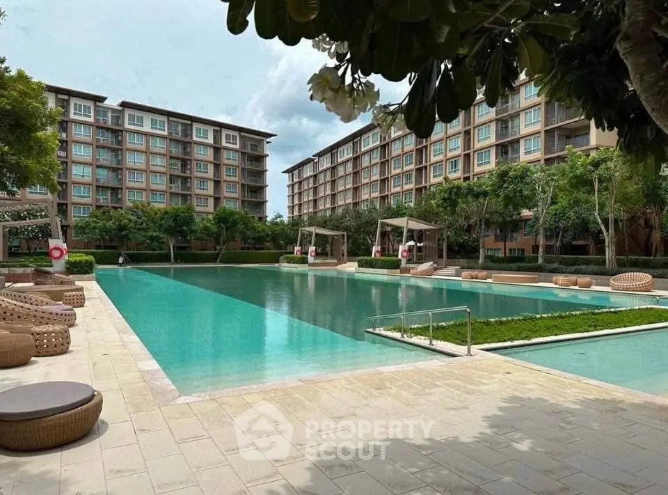 Luxurious residential complex with stunning pool and modern architecture.