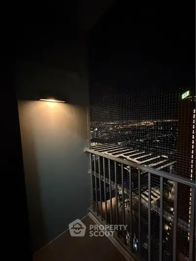 Stunning night view from a high-rise balcony with city lights panorama.