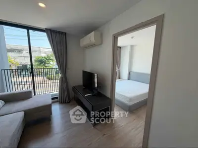 Modern apartment living room with balcony and bedroom view