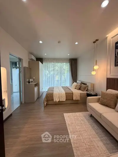 Luxurious bedroom with elegant decor and large window offering natural light and serene views.