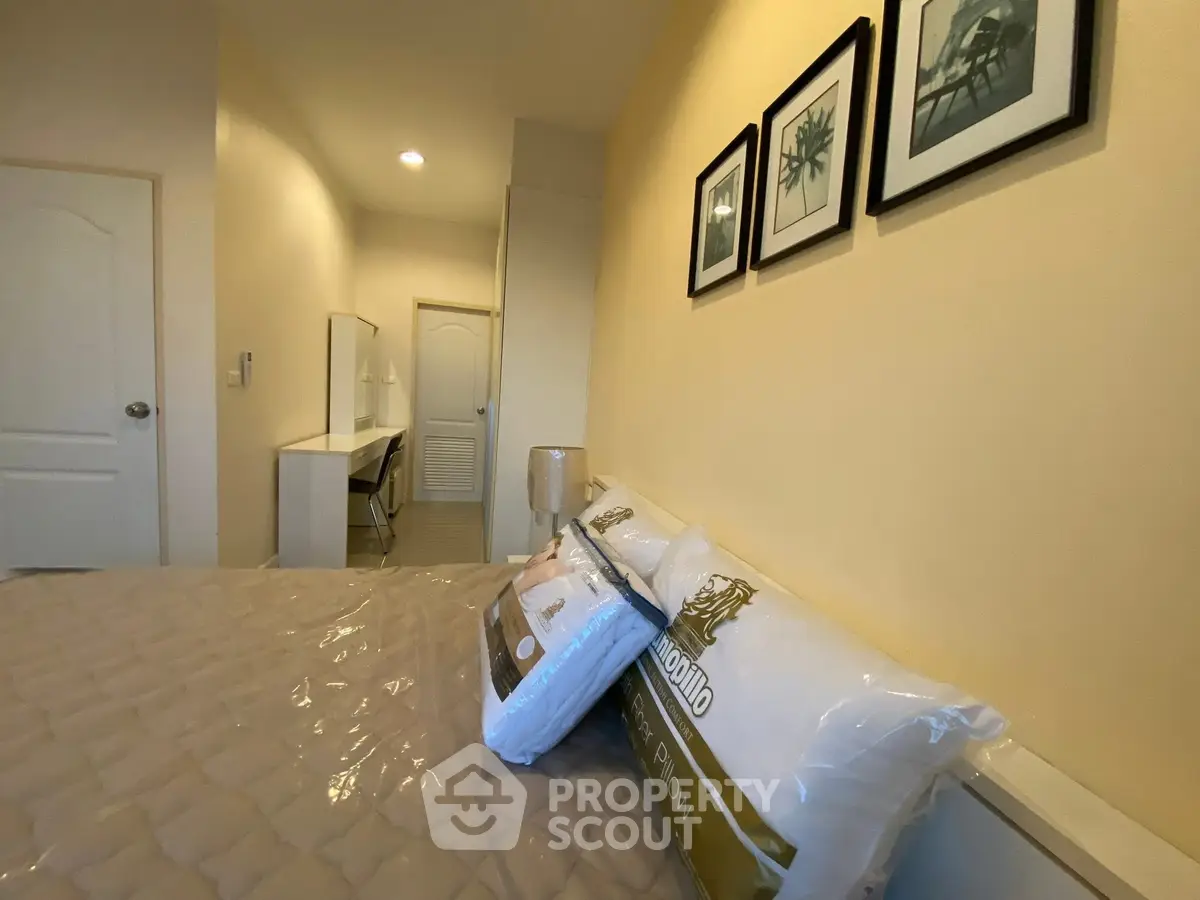 Cozy bedroom with modern decor and comfortable bedding in a stylish apartment.