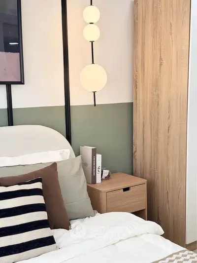 Stylish bedroom with modern decor and cozy ambiance, featuring elegant lighting and wooden furniture.