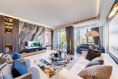 Luxurious modern living room with elegant decor and large windows offering stunning views.