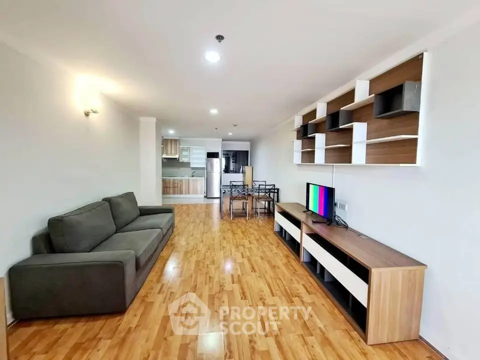 Spacious modern living room with open kitchen and stylish wooden flooring