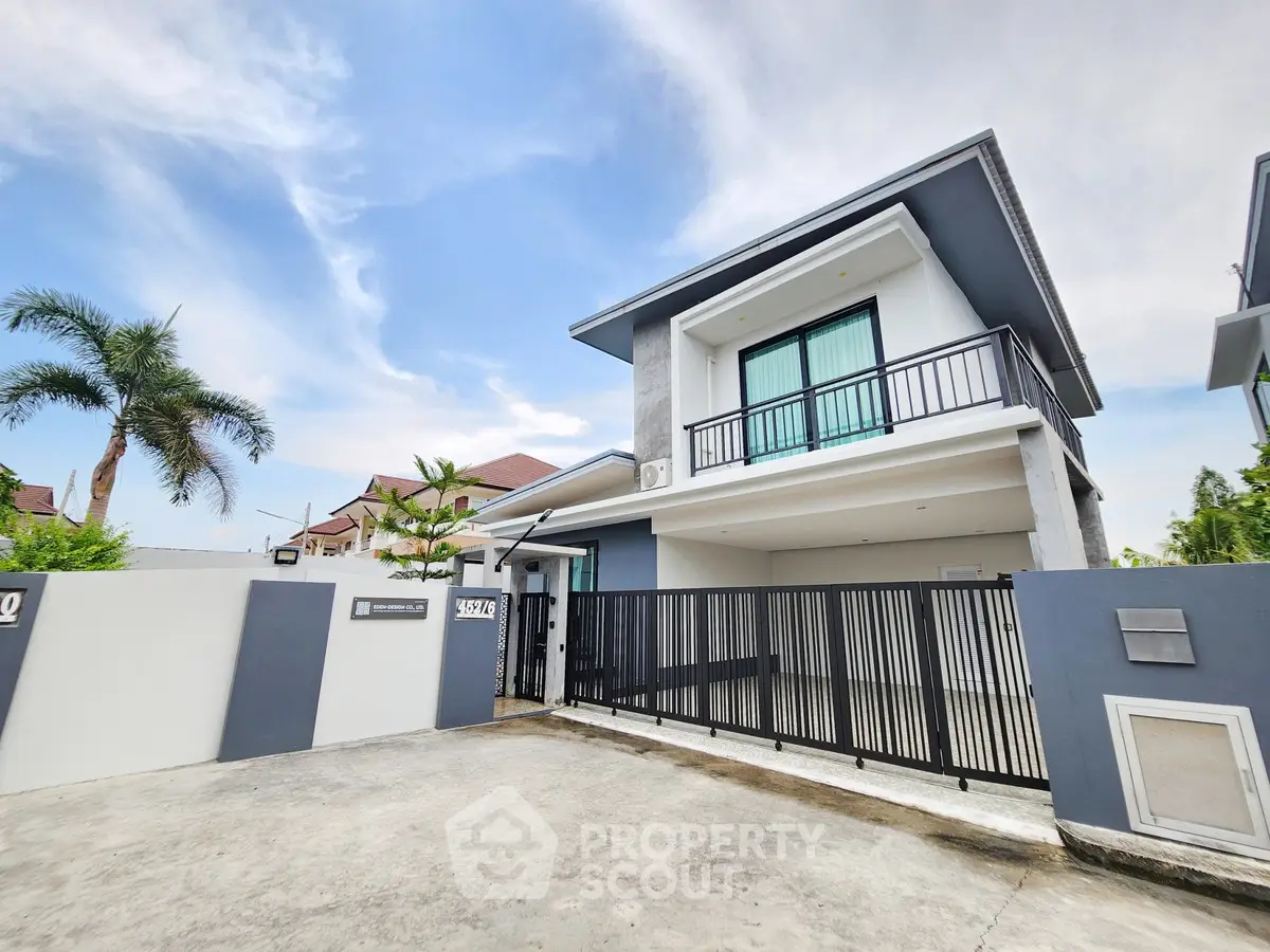 Modern two-story house with sleek design and spacious driveway