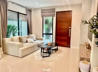 Modern living room with cozy sofa and stylish decor in a bright, inviting space.