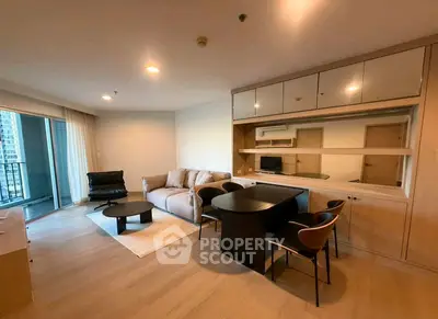Spacious modern living room with elegant furniture and large windows in a high-rise apartment.